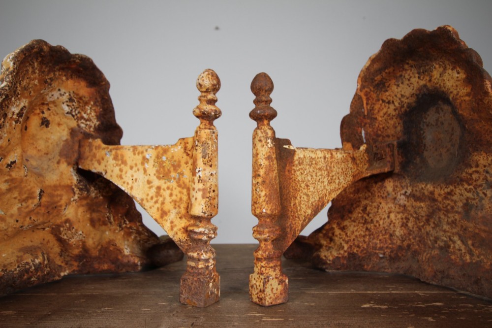 A pair of 19th-century cast iron recumbent lion boot scrapers featuring weathered cream paint and visible rust patination. View III