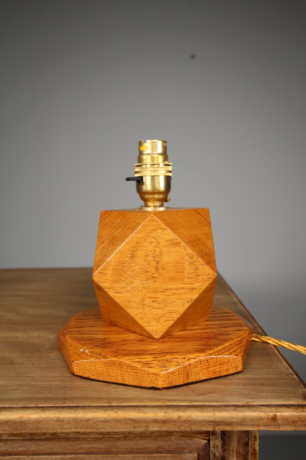A 1920s geometric oak table lamp base featuring a faceted polyhedral stem set on an octagonal stepped wooden base with a brass socket. View III