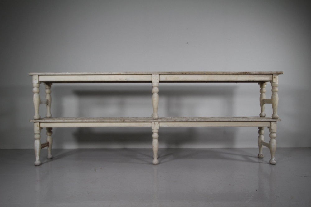 A pair of long 19th-century painted pine greenhouse benches featuring slatted tops and turned legs with lower stretchers. View II