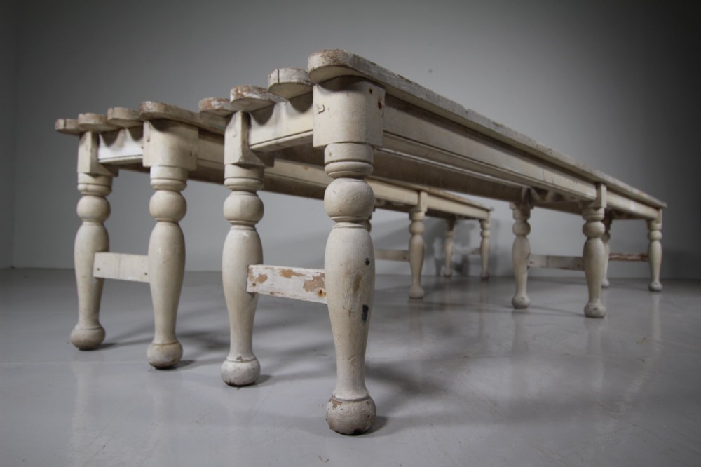 A pair of long 19th-century painted pine greenhouse benches featuring slatted tops and turned legs with lower stretchers. View IV
