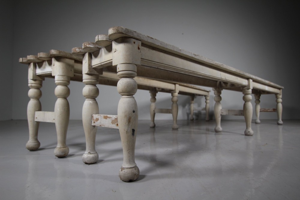 A pair of long 19th-century painted pine greenhouse benches featuring slatted tops and turned legs with lower stretchers. View V