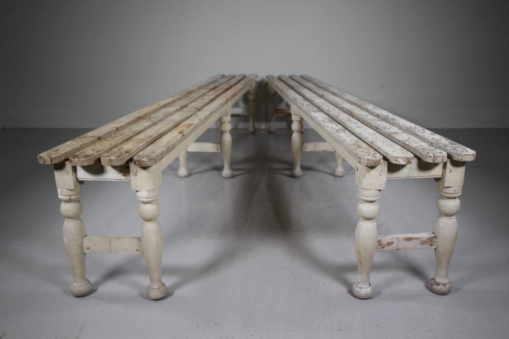 A pair of long 19th-century painted pine greenhouse benches featuring slatted tops and turned legs with lower stretchers. View VII