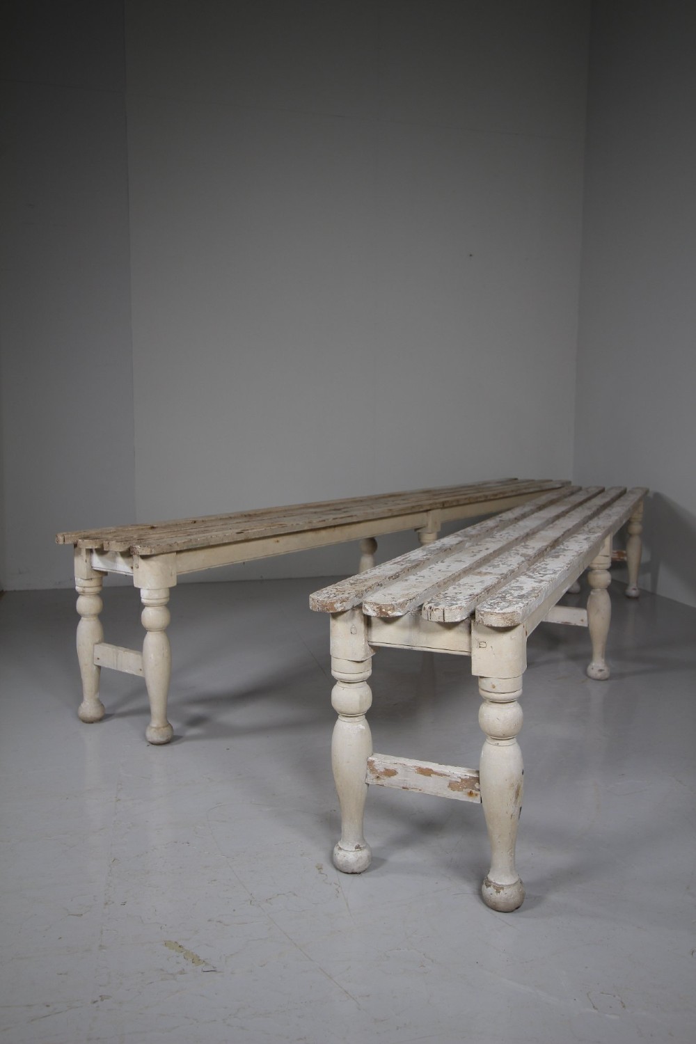 A pair of long 19th-century painted pine greenhouse benches featuring slatted tops and turned legs with lower stretchers. View VIII