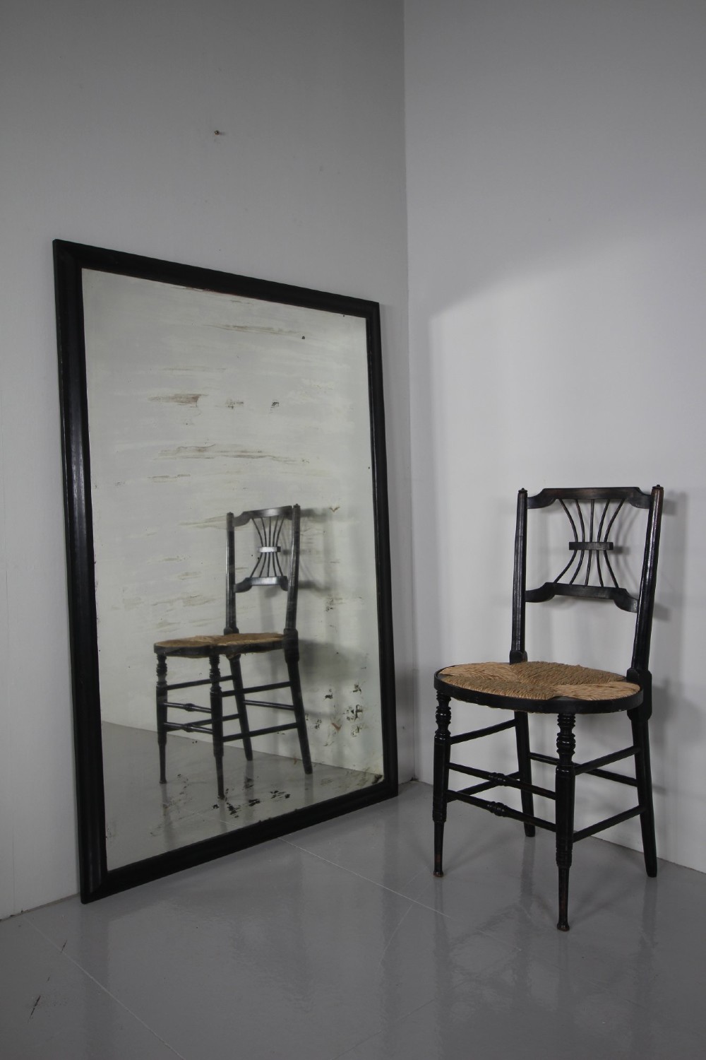 Large 19th-century rectangular mirror with a simple ebonised black wooden frame and patinated glass mirror. View IV