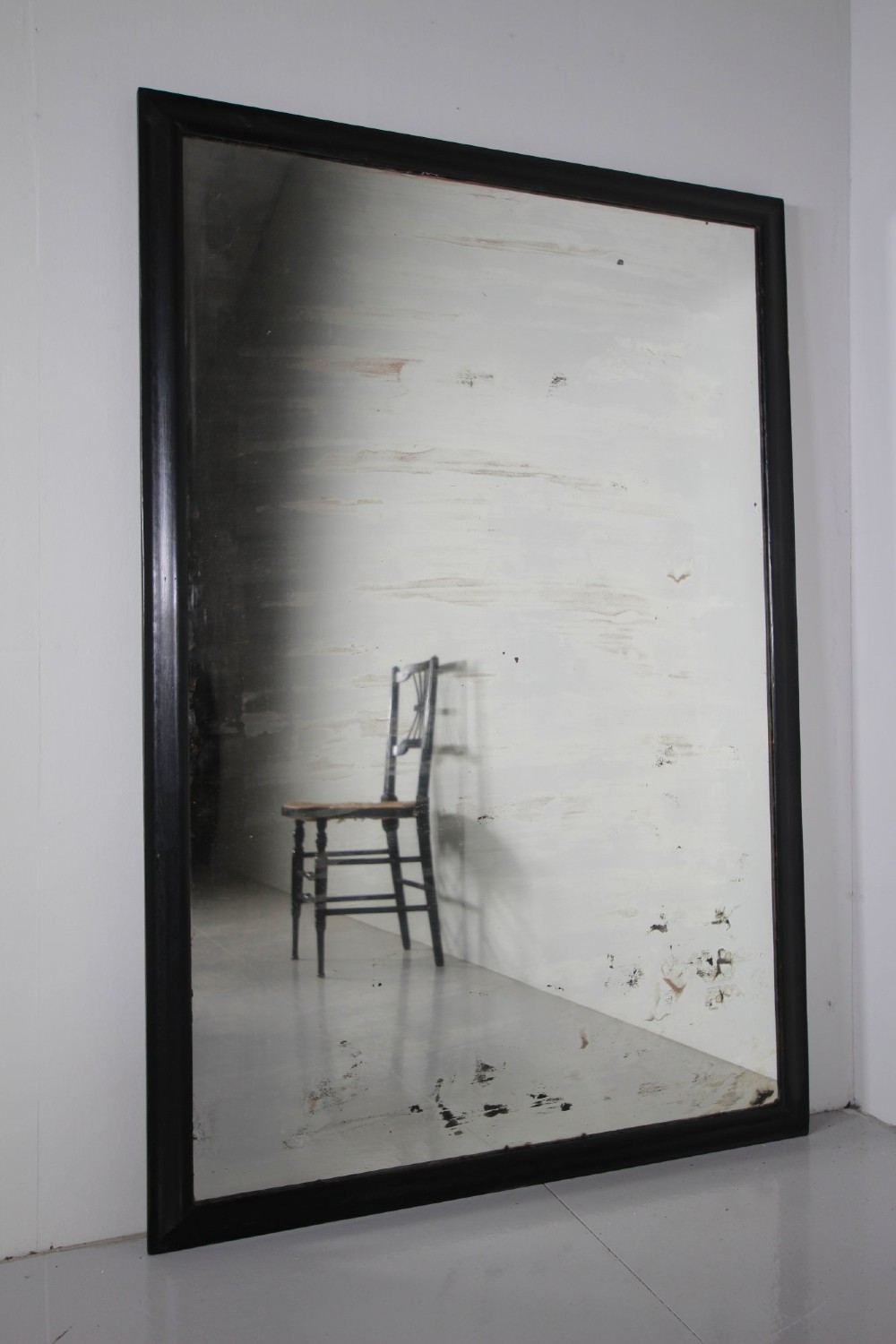 Large 19th-century rectangular mirror with a simple ebonised black wooden frame and patinated glass mirror. View VII