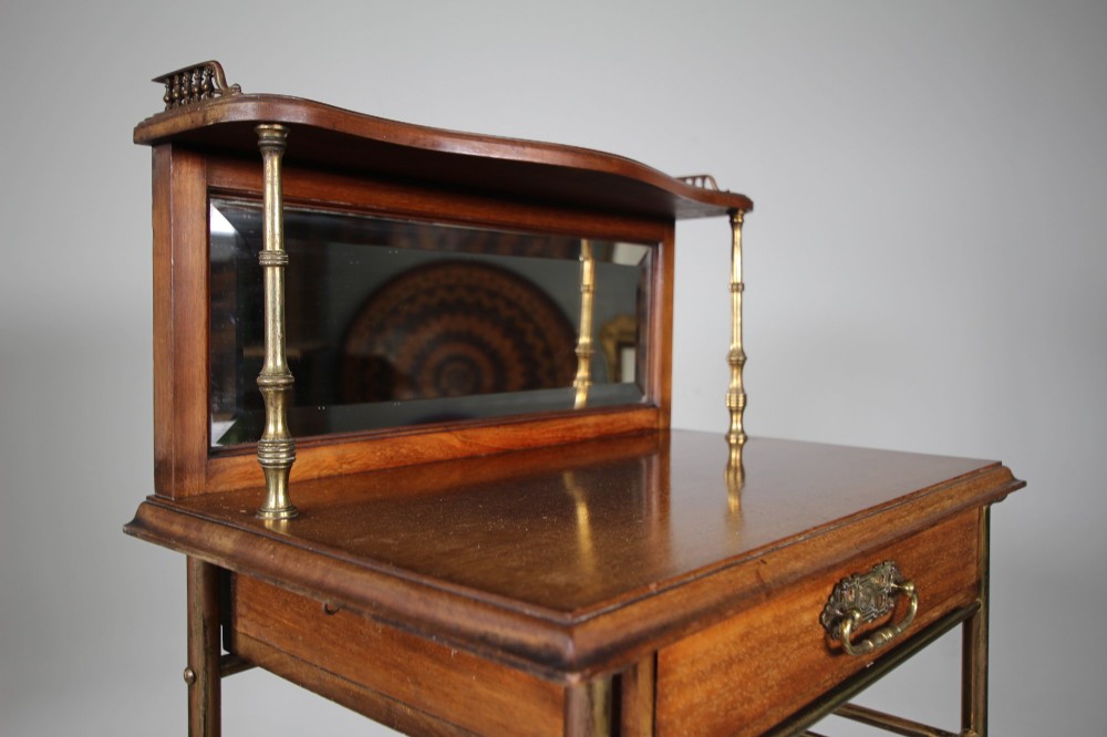 A 19th-century English Victorian brass and mahogany sheet music stand featuring open slatted shelves with ceramic labels, a top drawer, and a mirrored upper gallery. View II