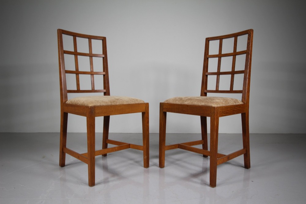 A set of six 1930s solid oak dining chairs featuring geometric lattice backs and upholstered neutral fabric seats. View III