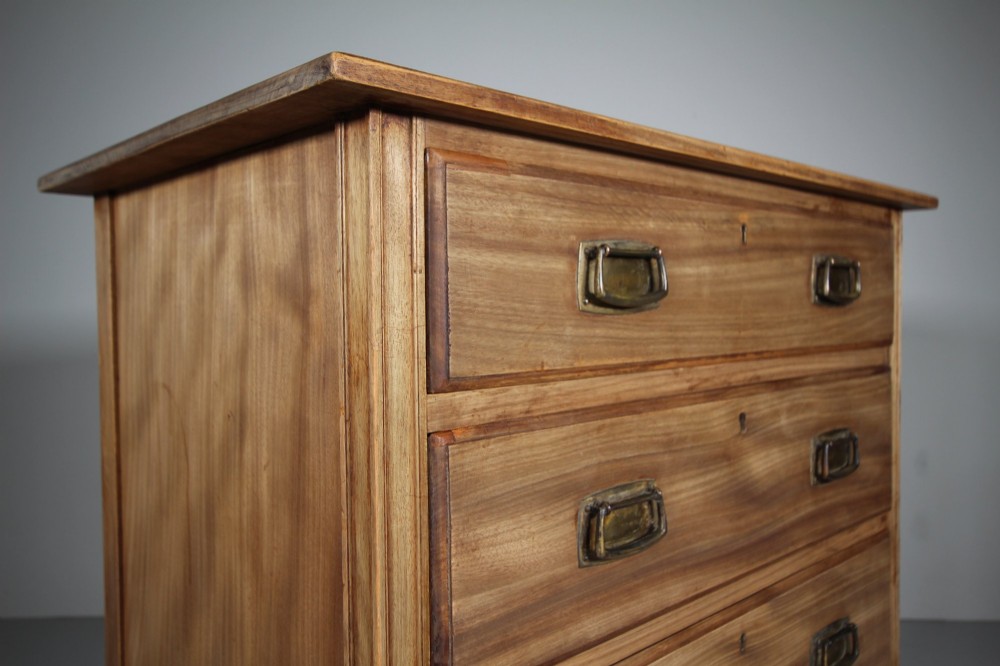 An antique colonial mahogany chest of drawers featuring four graduated drawers with flush brass handles standing on straight square legs. View II