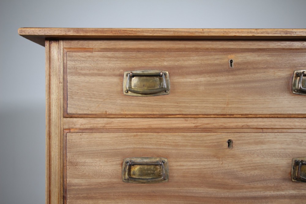 An antique colonial mahogany chest of drawers featuring four graduated drawers with flush brass handles standing on straight square legs. View IV