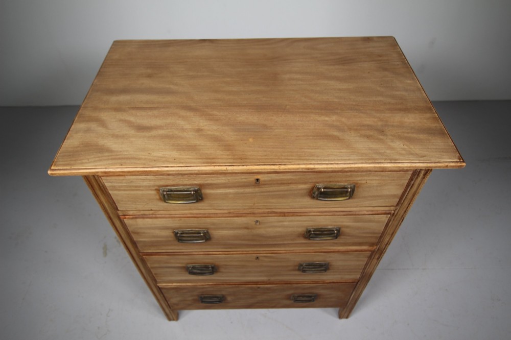 An antique colonial mahogany chest of drawers featuring four graduated drawers with flush brass handles standing on straight square legs. View VI