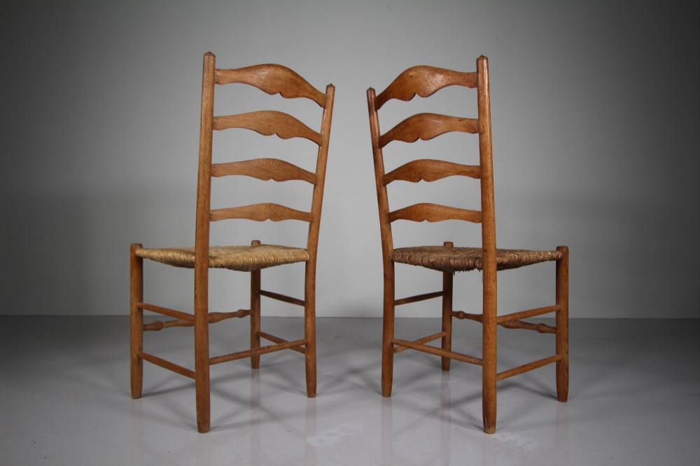 A pair of Arts and Crafts oak ladderback side chairs featuring hand-woven rush seats and four shaped back slats. View II
