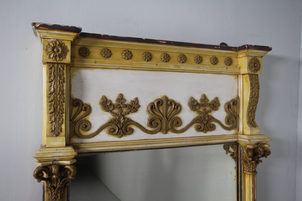 A tall nineteenth-century English Regency pier mirror featuring a cream and gilt frame flanked by fluted Corinthian columns and a decorated frieze. View II