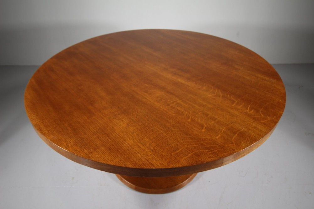 A 1930s circular oak dining table featuring a thick round top on a central octagonal pedestal column and round plinth base. View III