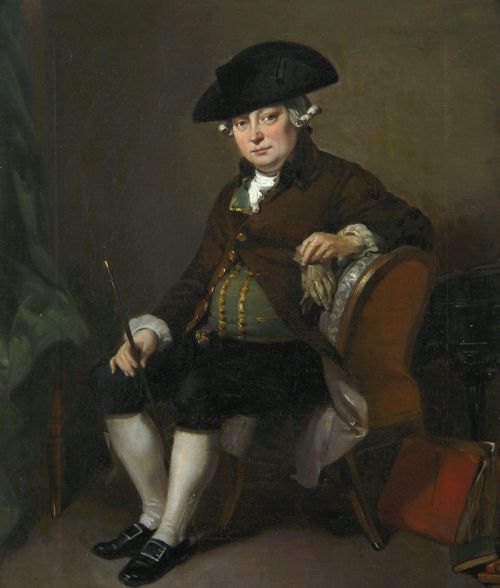 fig 1. An antique oil painting depicting a seated actor in 18th-century attire holding a cane, displayed inside an elaborate gold gilt frame.
