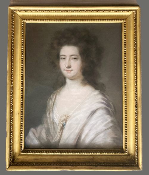 fig 1. A late 18th-century pastel portrait depicting a woman with voluminous brown hair wearing a draped white shawl and lace detail.