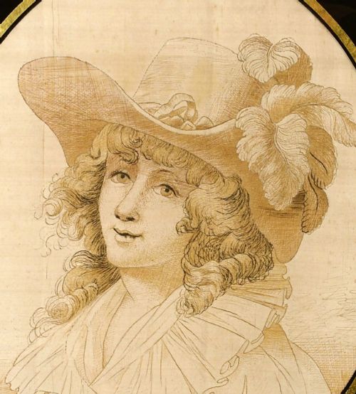 fig 1. An eighteenth-century woven silk portrait depicting a lady in a feathered hat, set in an oval border with a black and gold glass mount and gilt frame.