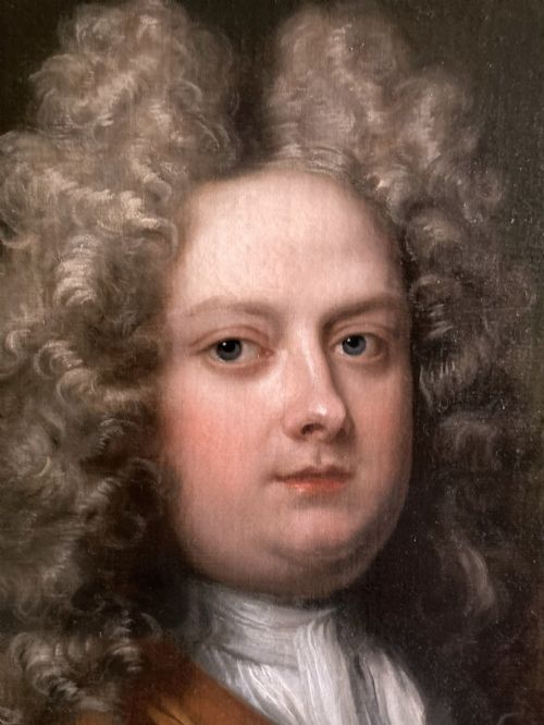 fig 4. An 18th-century oil portrait depicting a gentleman with a grey periwig and brown mantle within a feigned oval background.