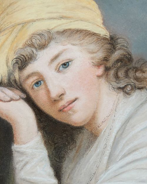 fig 2. An 18th-century oval portrait painting of a young woman wearing a white dress and yellow headpiece, housed within a rectangular gilded wooden frame with rosette corner details.