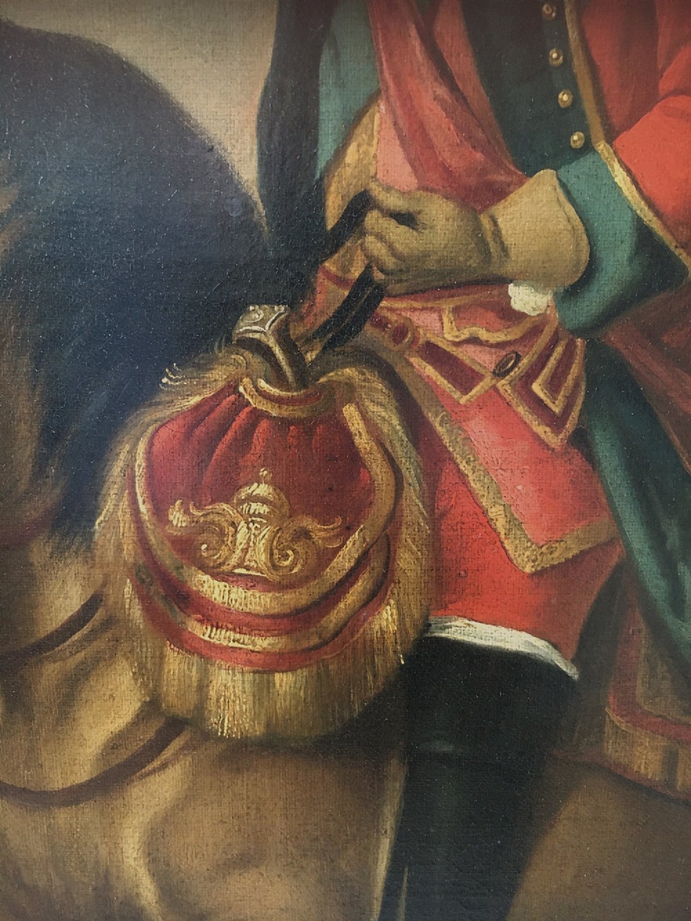 An 18th-century equestrian oil portrait depicting a military officer in a red coat mounted on a brown horse, enclosed in a carved giltwood frame. View III