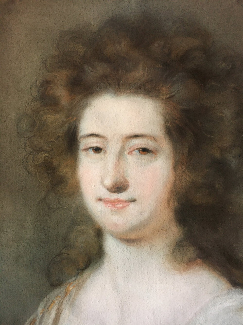 A late 18th-century pastel portrait depicting a woman with voluminous brown hair wearing a draped white shawl and lace detail. View IV