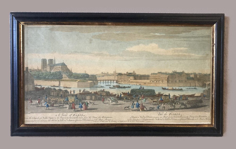 An 18th-century hand-coloured framed engraving depicting a panoramic view of Paris with Notre-Dame cathedral and figures along the River Seine. View II