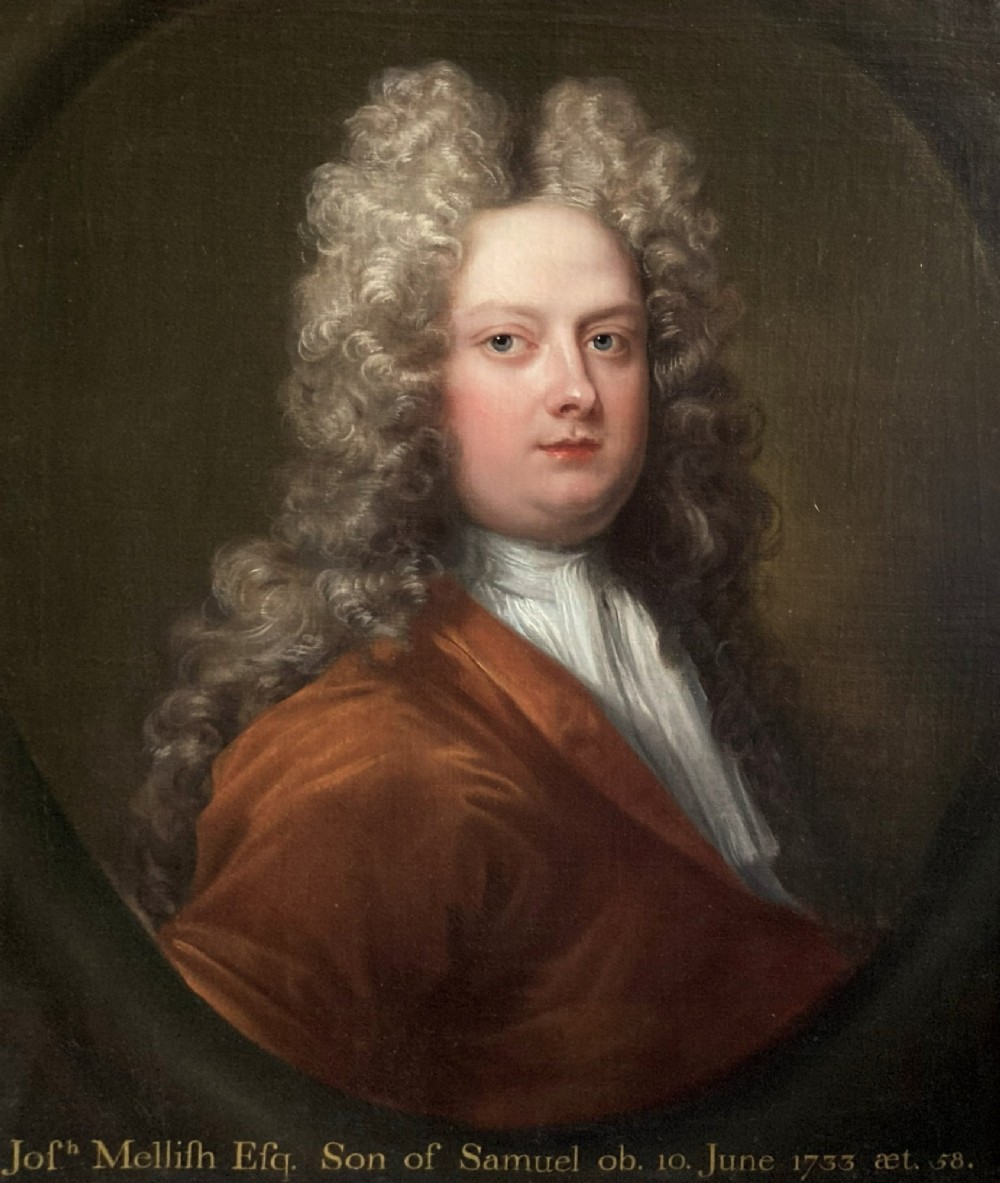 An 18th-century oil portrait depicting a gentleman with a grey periwig and brown mantle within a feigned oval background.