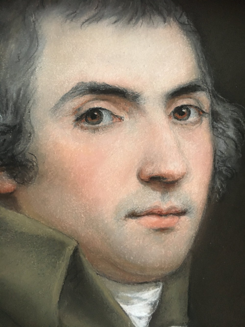 An oval portrait of a gentleman wearing a brown jacket, set within a square gilded spandrel frame and dark outer ebonised border. View III