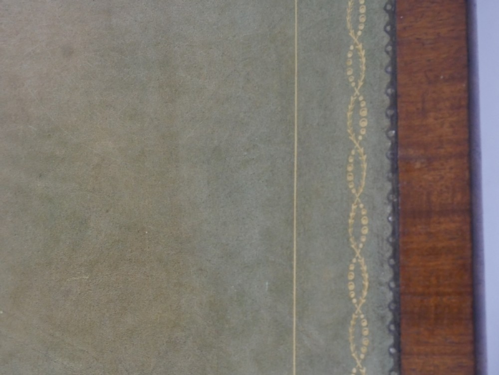A 19th-century mahogany side table featuring an inset olive green leather top, supported by a trestle base with carved scroll feet. View XI