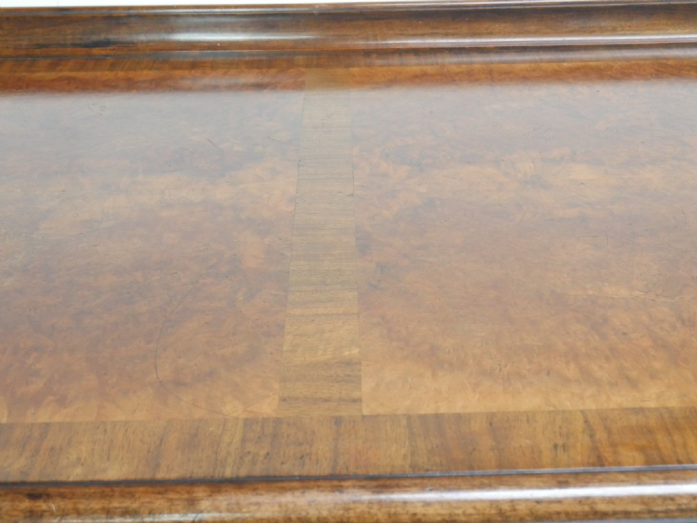 A large antique Scottish mahogany and walnut serving table featuring four brass-handled drawers, carved scroll leg supports, and a low rear gallery back. View XI
