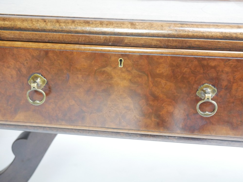 A large antique Scottish mahogany and walnut serving table featuring four brass-handled drawers, carved scroll leg supports, and a low rear gallery back. View XVIII