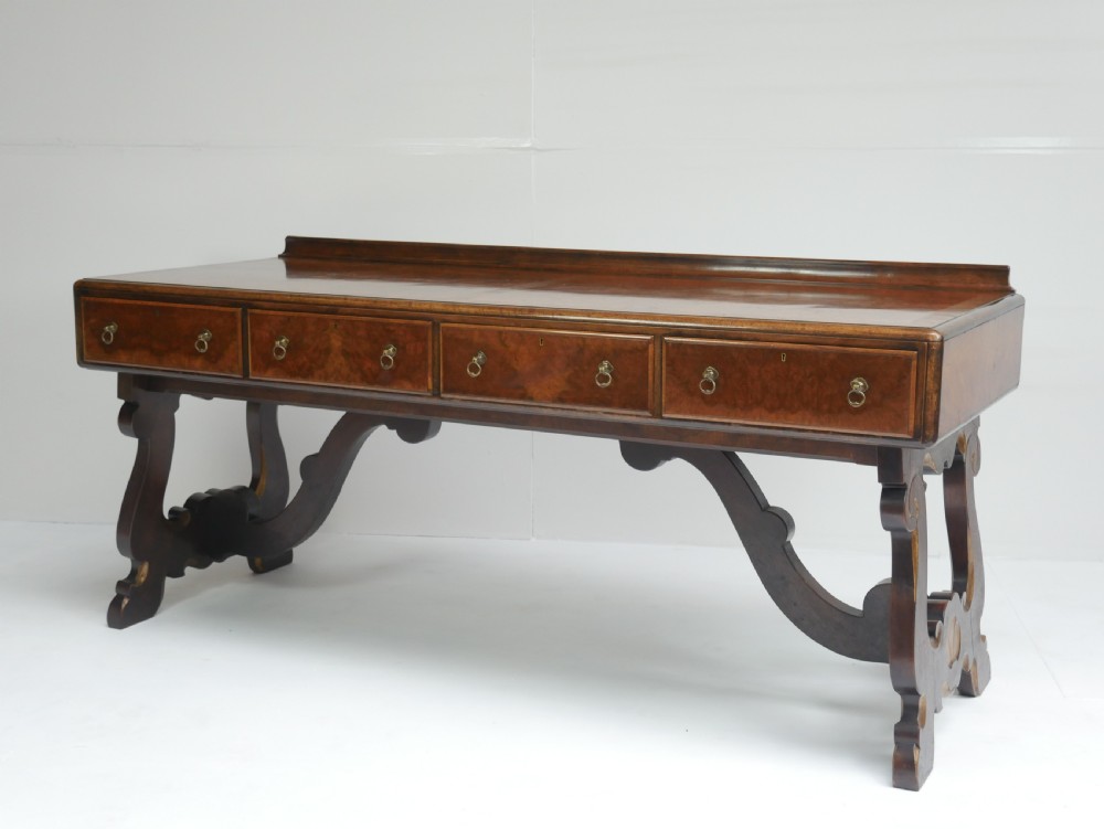 A large antique Scottish mahogany and walnut serving table featuring four brass-handled drawers, carved scroll leg supports, and a low rear gallery back. View XIX