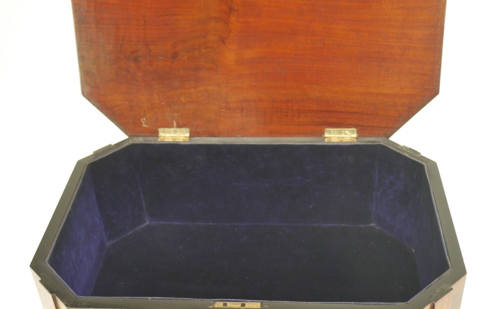 A Sheraton period mahogany occasional table featuring three stacked drawers, canted corners, splayed legs with brass castors, and an X-stretcher. View VIII