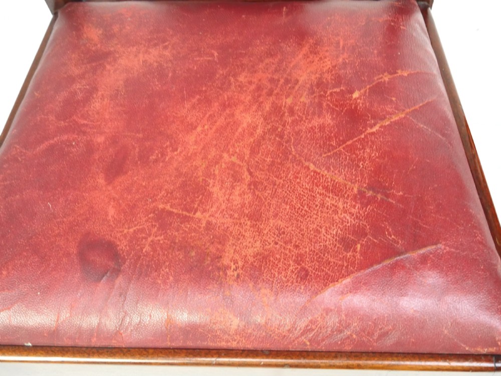 A pair of 19th-century mahogany side chairs with pierced back splats, serpentine top rails, straight legs with stretchers, and red leather seats. View II