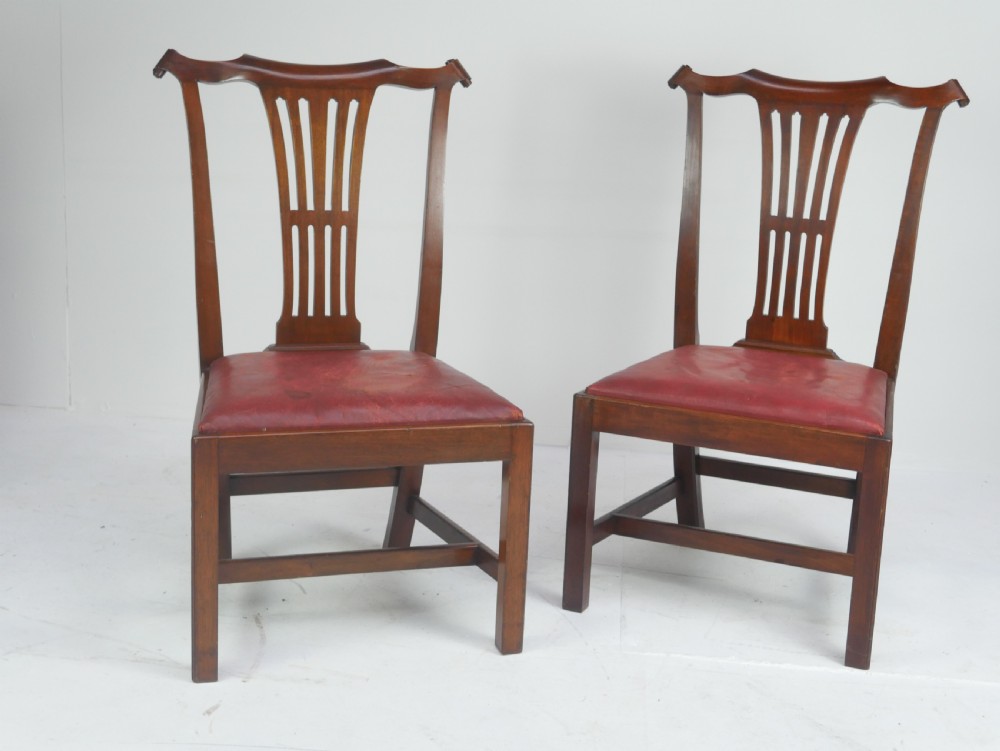 A pair of 19th-century mahogany side chairs with pierced back splats, serpentine top rails, straight legs with stretchers, and red leather seats. View III