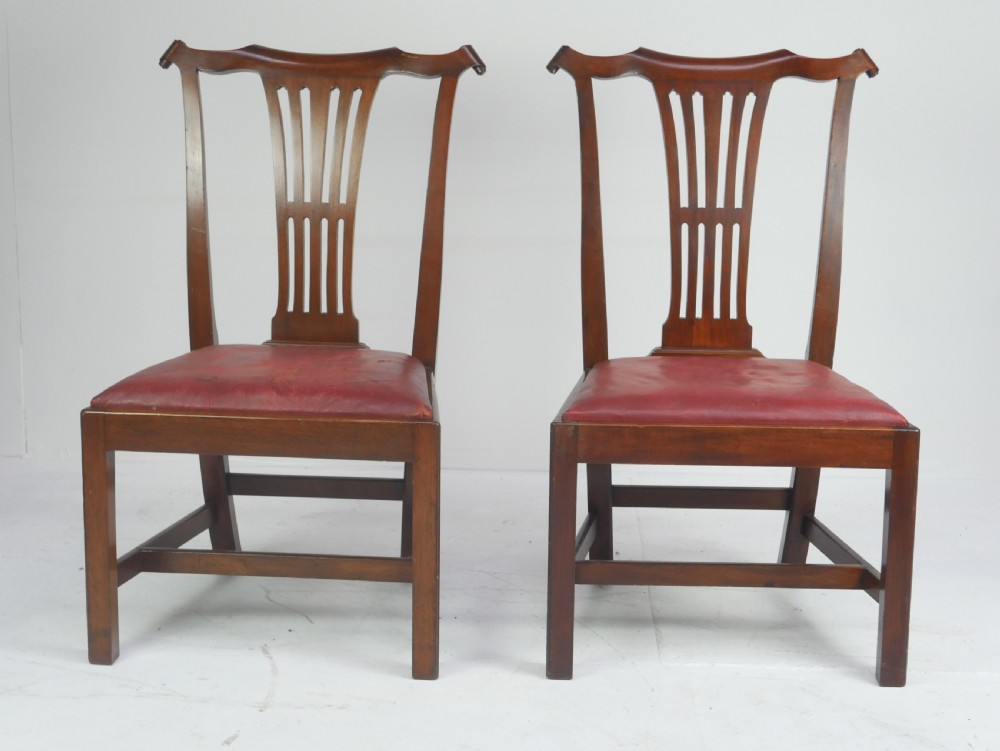 A pair of 19th-century mahogany side chairs with pierced back splats, serpentine top rails, straight legs with stretchers, and red leather seats. View XI