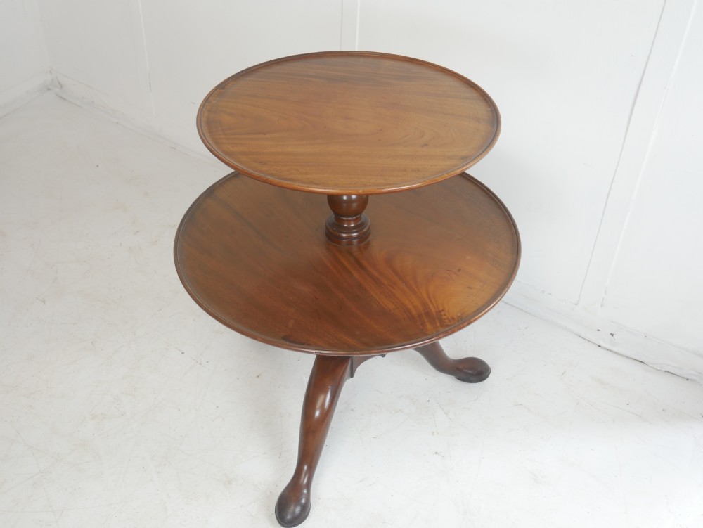 An 18th-century Georgian mahogany two-tier dumb waiter table with two graduated circular tray-moulded platforms on a turned baluster column and tripod pad feet. View II