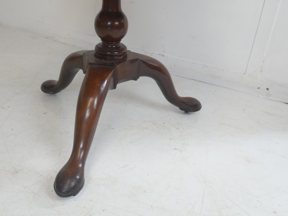 An 18th-century Georgian mahogany two-tier dumb waiter table with two graduated circular tray-moulded platforms on a turned baluster column and tripod pad feet. View VI