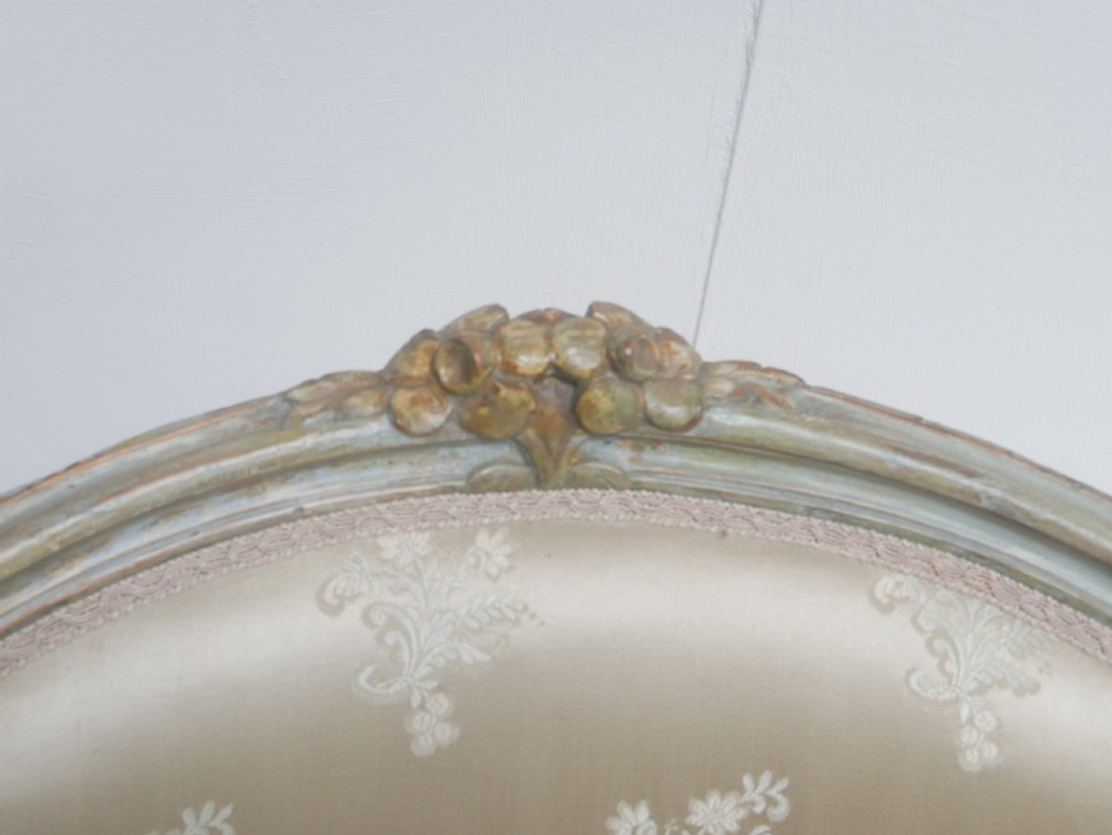A pair of antique Scandinavian armchairs featuring pale green carved painted frames, cabriole legs, and cream floral pattern damask upholstery. View II