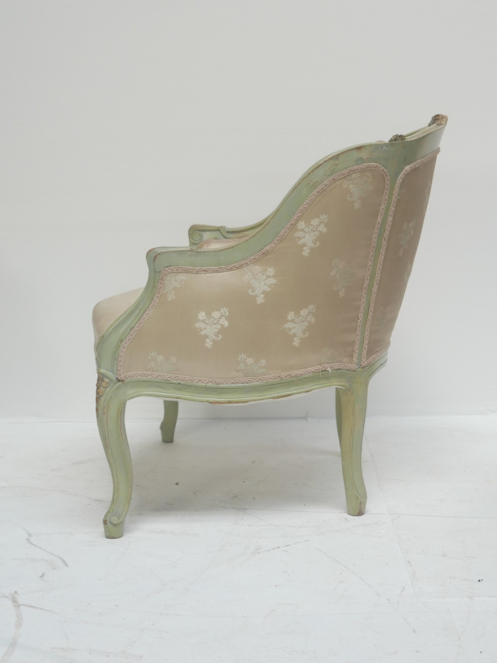 A pair of antique Scandinavian armchairs featuring pale green carved painted frames, cabriole legs, and cream floral pattern damask upholstery. View V