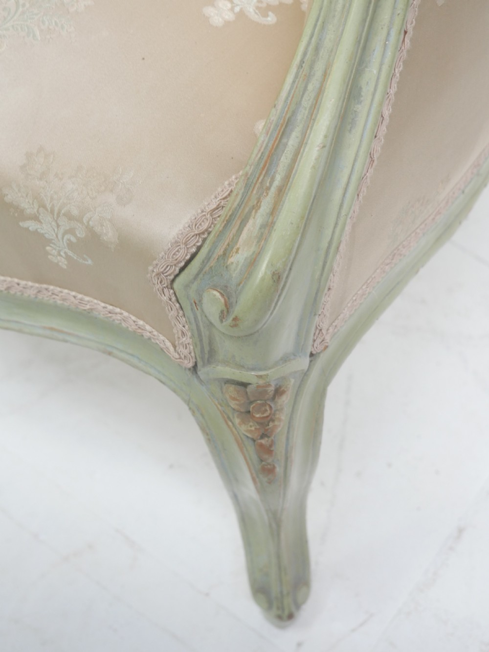 A pair of antique Scandinavian armchairs featuring pale green carved painted frames, cabriole legs, and cream floral pattern damask upholstery. View X