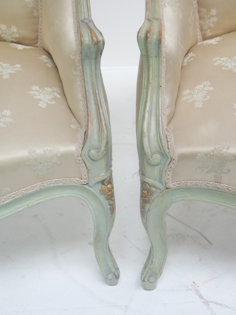 A pair of antique Scandinavian armchairs featuring pale green carved painted frames, cabriole legs, and cream floral pattern damask upholstery. View XIII