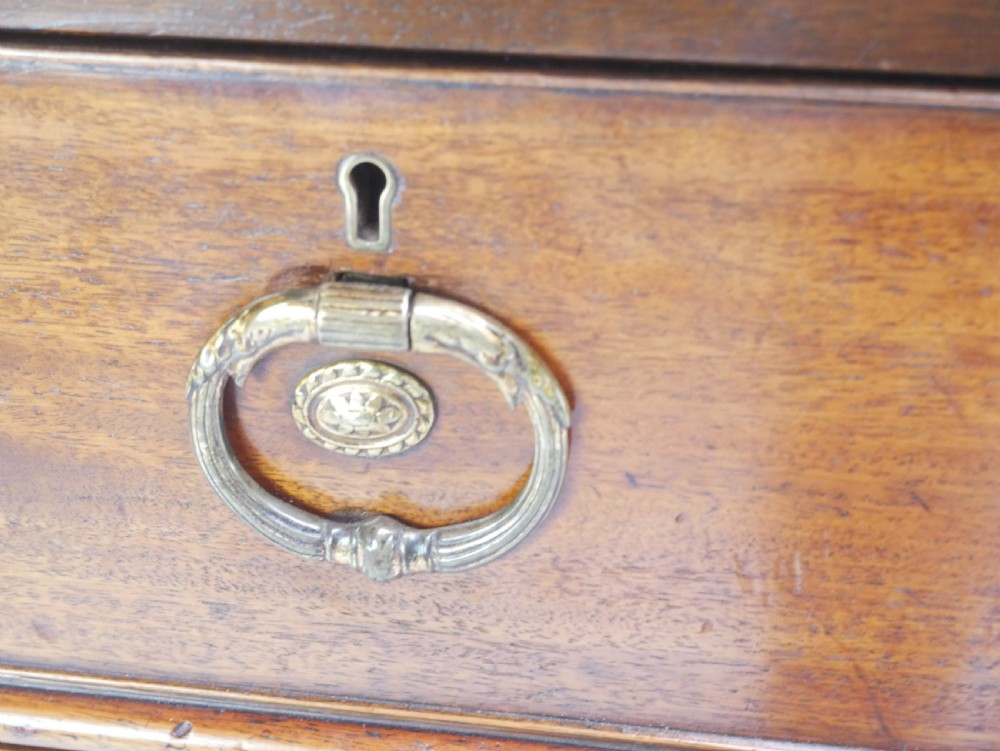 A Georgian mahogany kneehole desk featuring multiple side drawers with brass ring handles and a plinth base. View VI