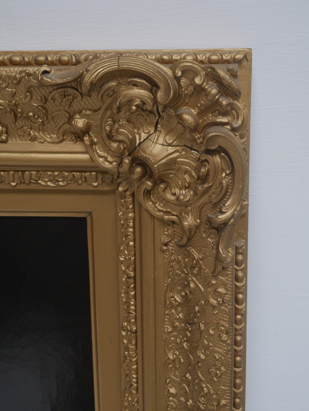 A 19th-century oil painting depicting a gentleman in formal dark attire, framed within an elaborate gold gilt frame. View V