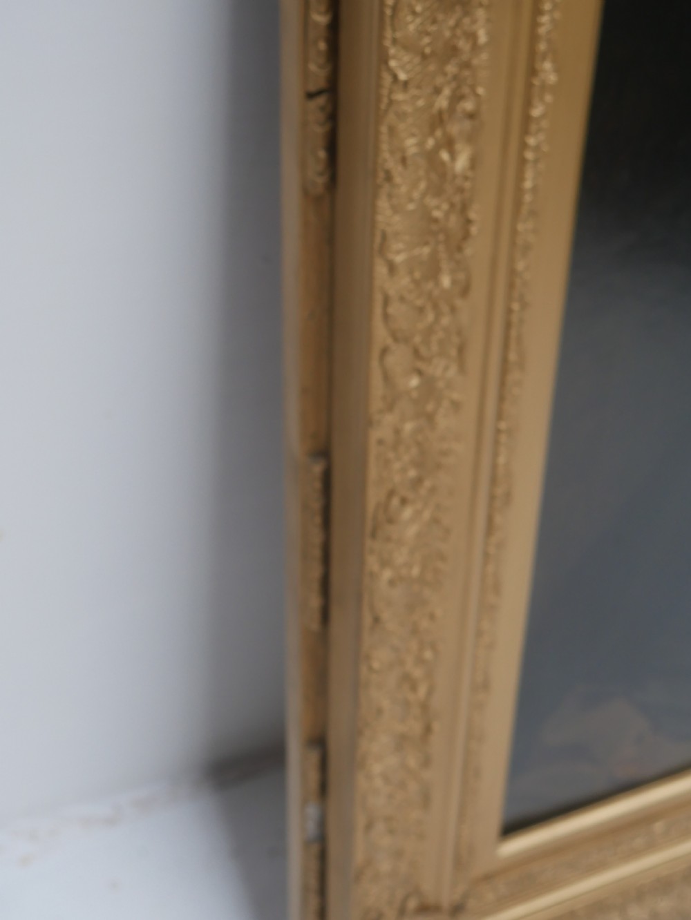 A 19th-century oil painting depicting a gentleman in formal dark attire, framed within an elaborate gold gilt frame. View VII
