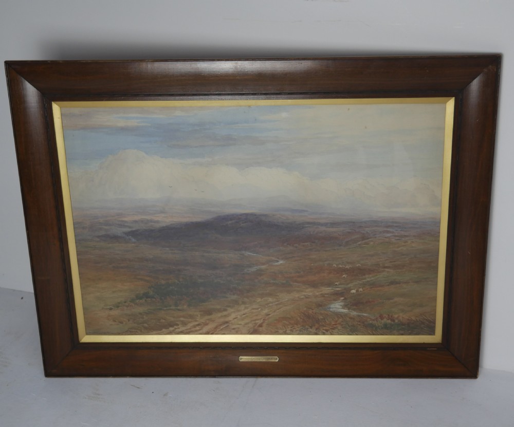 A framed Victorian watercolour landscape painting by Arthur H. Enock showing the Isle of Man moorland under a cloudy sky.