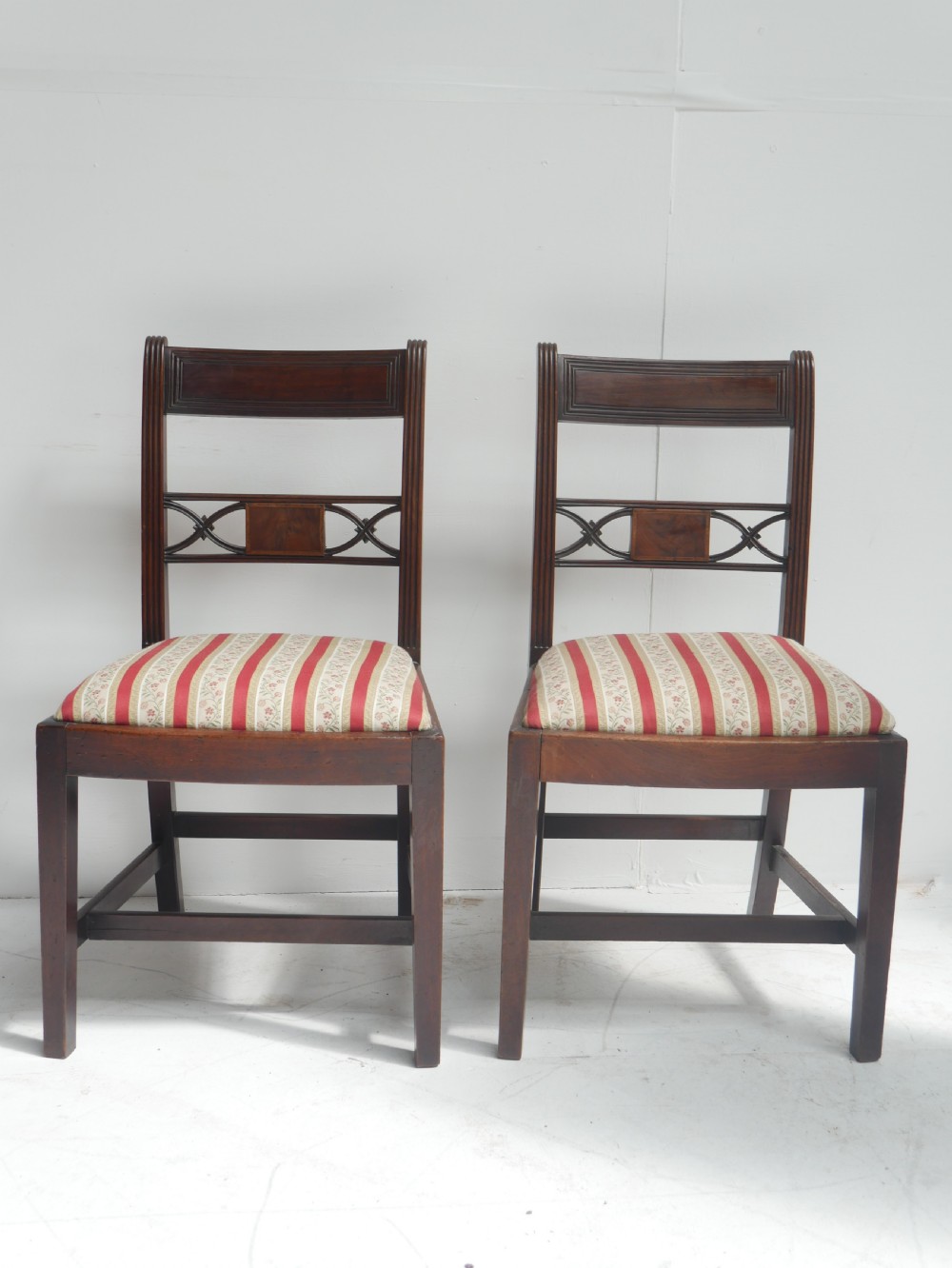 Set of four dark mahogany Regency dining chairs with reeded frames and red and cream striped fabric seats. View II