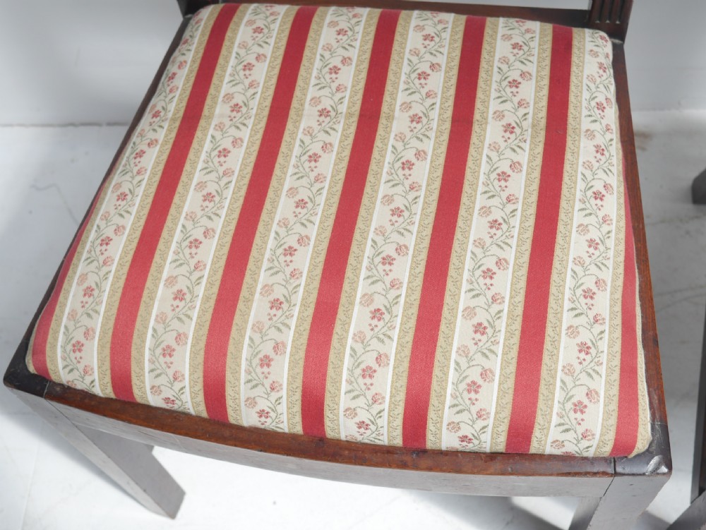 Set of four dark mahogany Regency dining chairs with reeded frames and red and cream striped fabric seats. View V