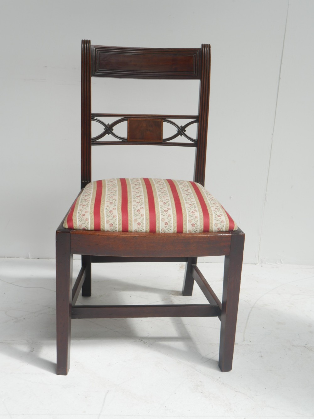 Set of four dark mahogany Regency dining chairs with reeded frames and red and cream striped fabric seats. View VI
