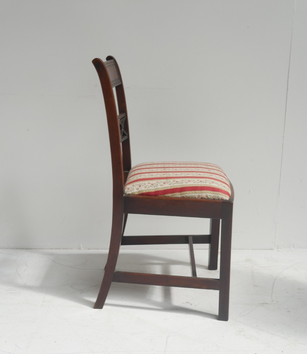 Set of four dark mahogany Regency dining chairs with reeded frames and red and cream striped fabric seats. View VII