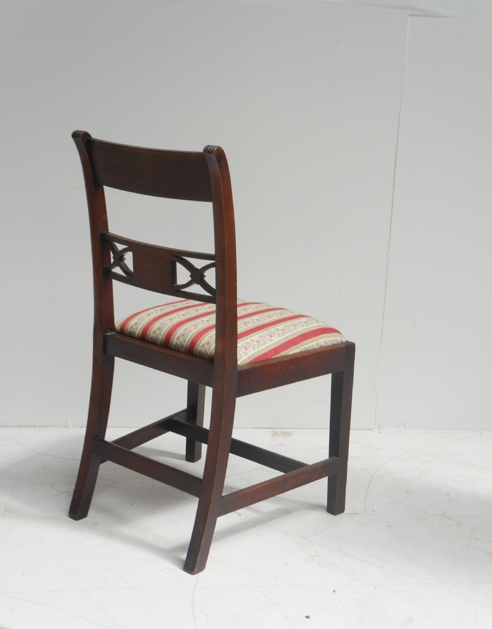 Set of four dark mahogany Regency dining chairs with reeded frames and red and cream striped fabric seats. View VIII